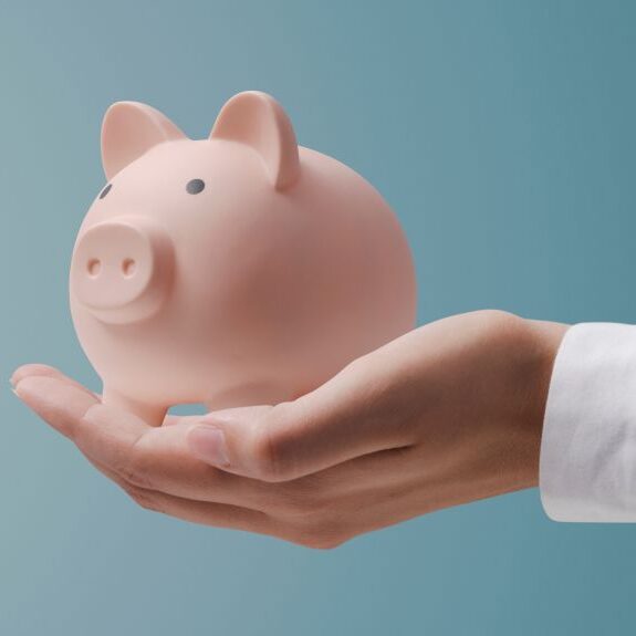 Doctor holding a piggy bank